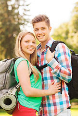 Image showing smiling couple with backpacks in nature