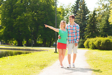 Image showing smiling couple walking in park