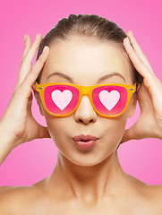 Image showing surprised teenage girl in pink sunglasses