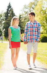 Image showing smiling couple walking in park