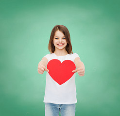 Image showing beautiful little girl sitting at table