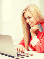 Image showing businesswoman with laptop using credit card