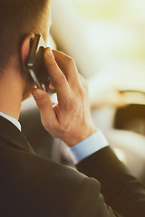 Image showing man using phone while driving the car