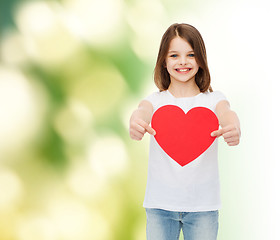 Image showing beautiful little girl sitting at table