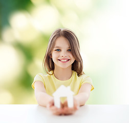 Image showing beautiful little girl holding paper house cutout