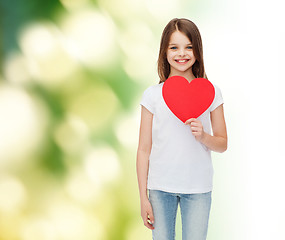 Image showing beautiful little girl sitting at table