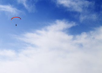 Image showing Silhouette of skydiver at sky