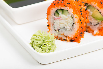 Image showing Macro shot of wasabi with rolls on background