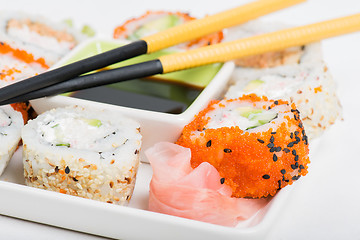 Image showing Soy sauce, chopsticks and sushi mix