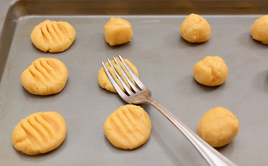 Image showing Flattening balls of cookie dough 