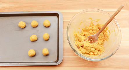 Image showing Adding balls of cookie dough to a baking sheet