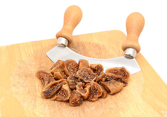 Image showing Chopped soft dried figs with a rocking knife