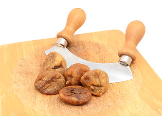 Image showing Whole soft dried figs with a rocking knife 