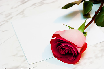 Image showing Red rose and a blank sheet of paper