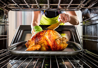 Image showing Cooking chicken in the oven at home.