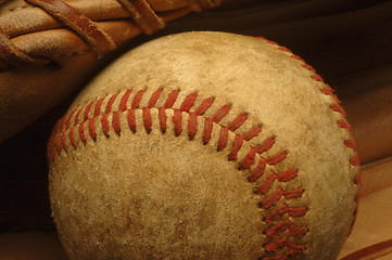 Image showing Old well-worn Baseball in a glove.