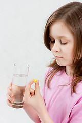 Image showing Teen girl takes medicine