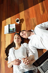 Image showing relaxed young couple working on laptop computer at home