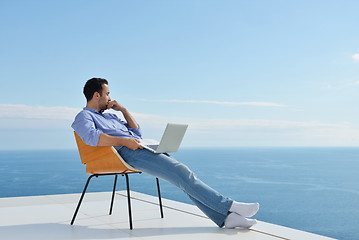 Image showing relaxed young man at home on balcony