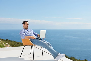 Image showing relaxed young man at home on balcony