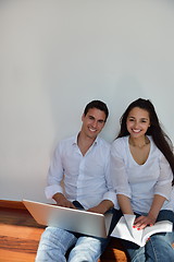 Image showing relaxed young couple working on laptop computer at home