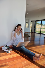 Image showing relaxed young woman at home working on laptop