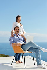 Image showing relaxed young couple working on laptop computer at home