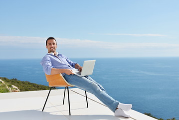 Image showing relaxed young man at home on balcony