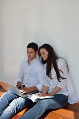 Image showing relaxed young couple working on laptop computer at home