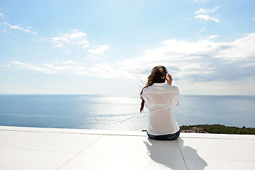 Image showing girl listening to the music on white headphones