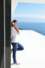 Image showing girl listening to the music on white headphones