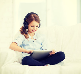 Image showing girl with tablet pc and headphones at home