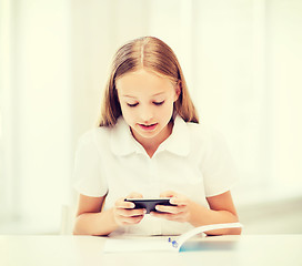 Image showing girl with smartphone at school