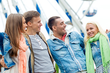 Image showing group of smiling friends in amusement park