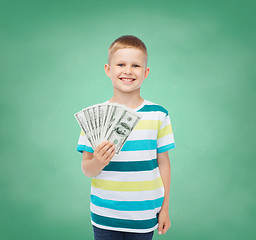 Image showing smiling boy holding dollar cash money in his hand