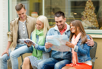 Image showing group of friends with guide and map exploring town