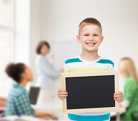 Image showing smiling little boy holding blank black chalkboard