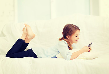 Image showing smiling girl with smartphone at home