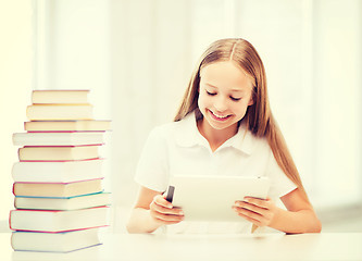 Image showing girl with tablet pc and books at school