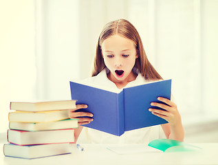 Image showing girl studying and reading book at school