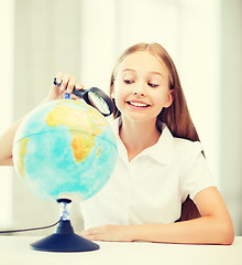 Image showing child looking at globe with magnifier