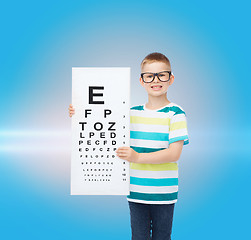 Image showing smiling boy in eyeglasses with white blank board