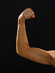 Image showing close up of athletic woman flexing her biceps