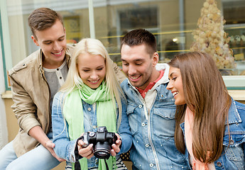 Image showing group of smiling friends with digital photocamera