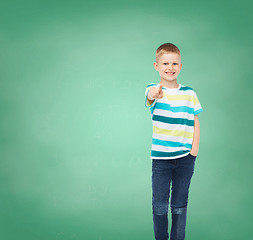 Image showing Little boy in casual clothes pointing his finger