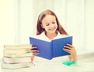 Image showing girl studying and reading book at school