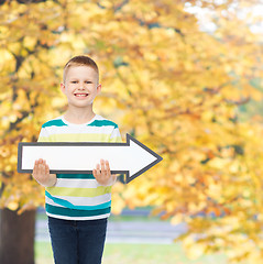 Image showing smiling little boy with blank arrow pointing right