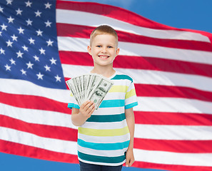 Image showing smiling boy holding dollar cash money in his hand