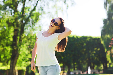 Image showing smiling young woman with sunglasses in park