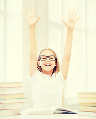 Image showing girl with books and hands up